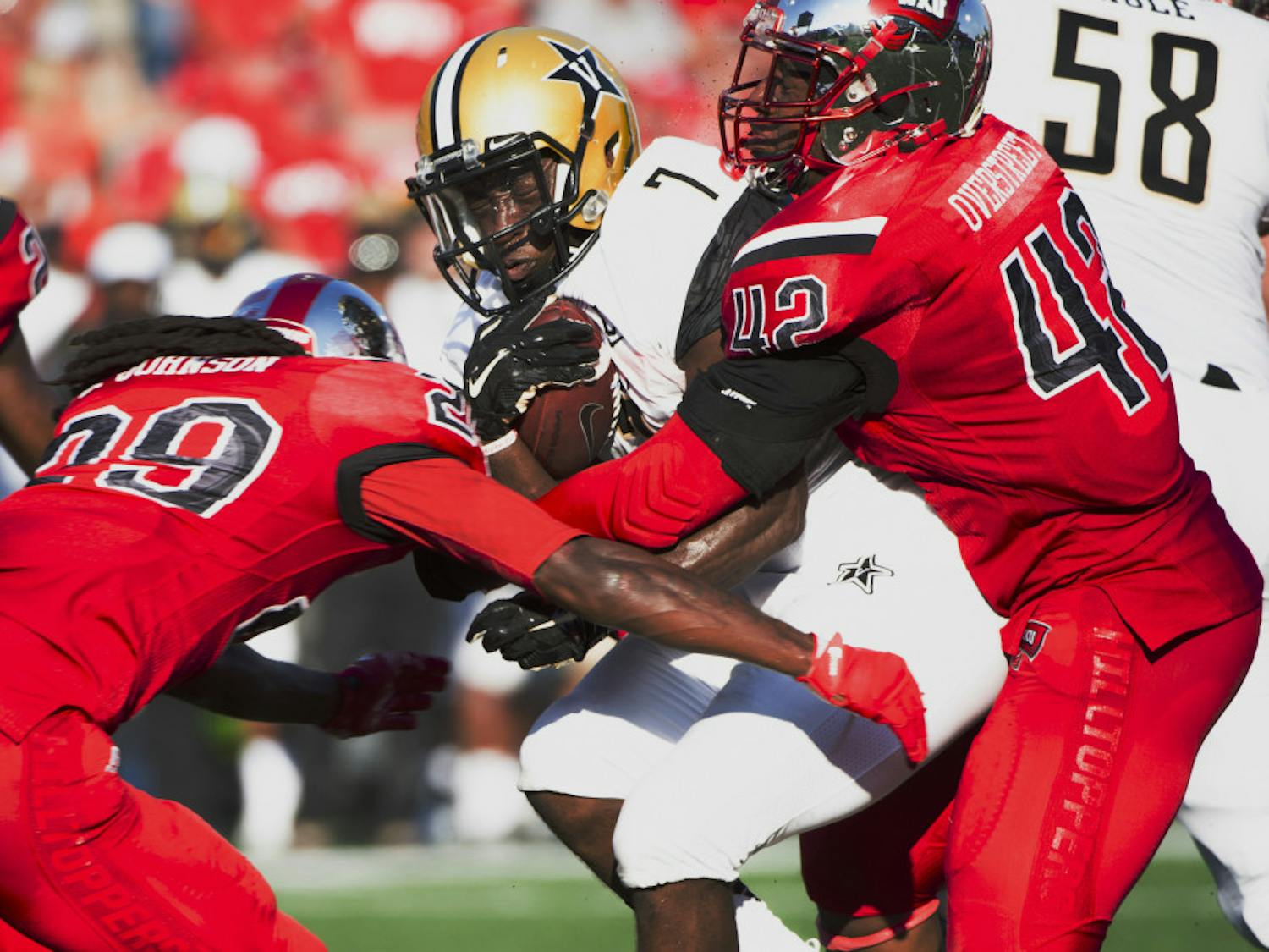 Vanderbilt University running back Ralph Webb (7) is tackled by multiple Western Kentucky University players in an NCAA college football game, Saturday, Sept. 24, 2016, in Bowling Green, Ky. (AP Photo/Michael Noble Jr.)