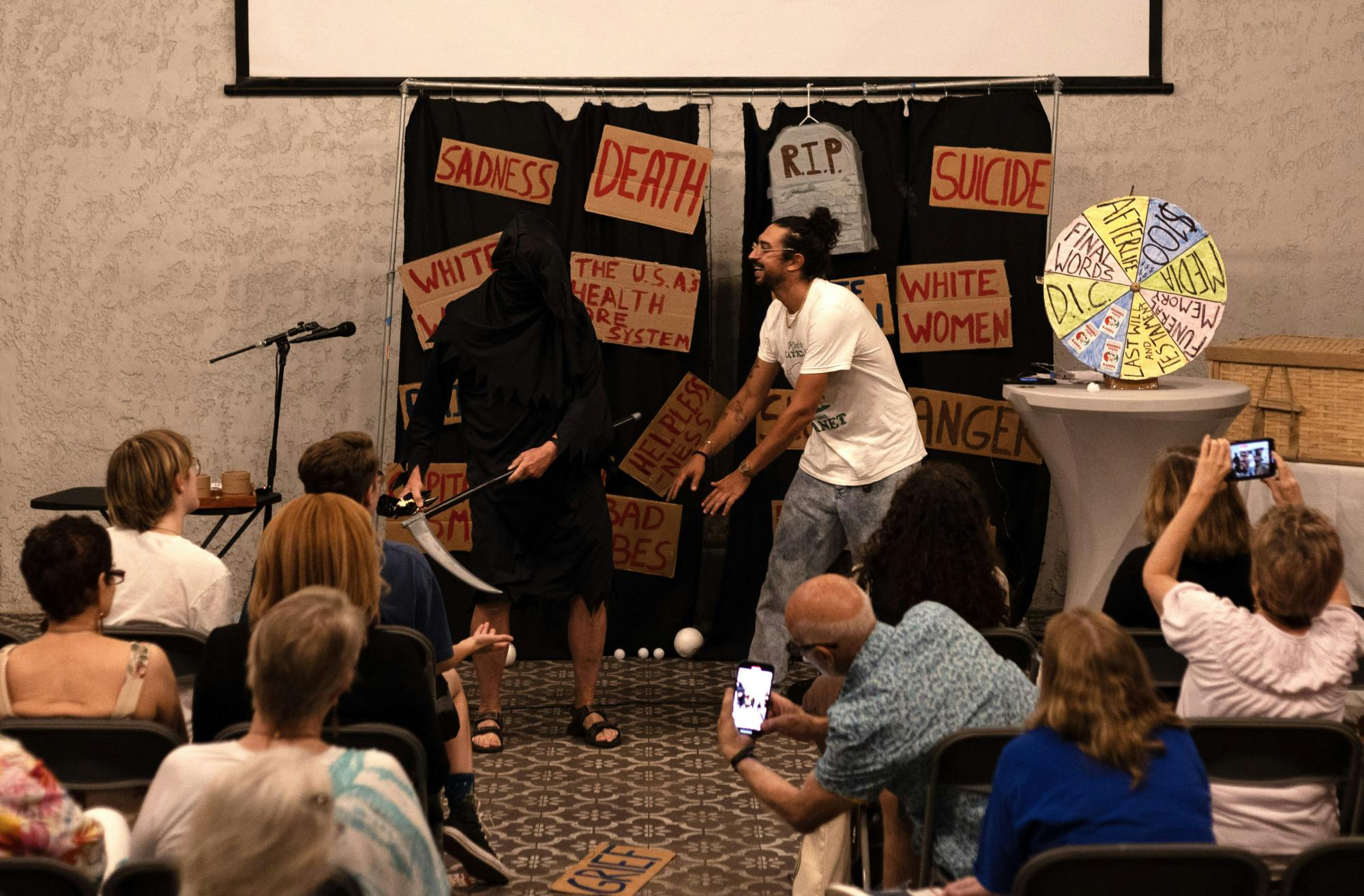 Comedian Ben Wasserman dances with a grimly veiled John Freeman in the show’s closing moments on Sunday, Sept. 17, 2023 at Cypress &amp; Grove Brewing Co.