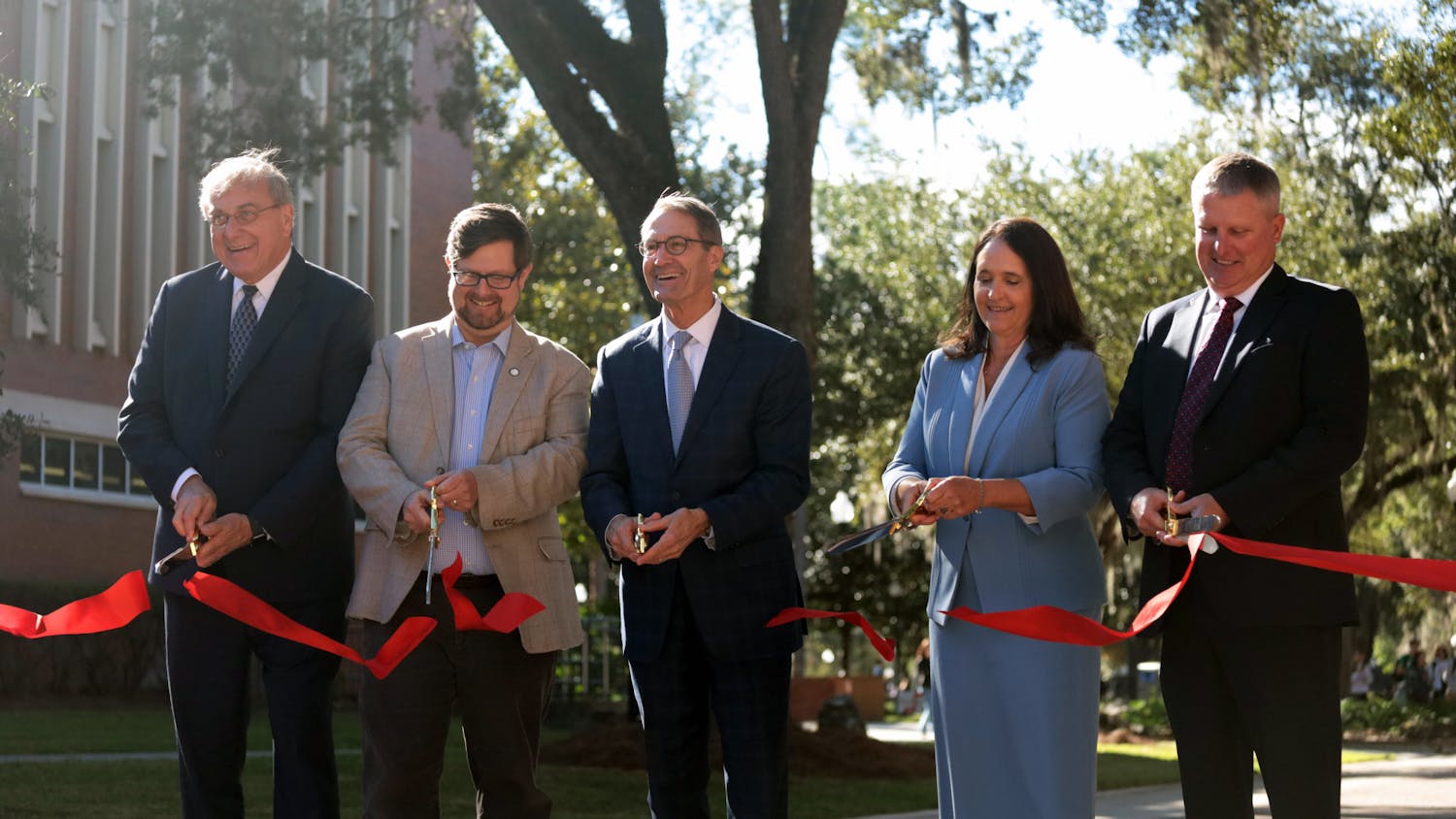 UF President Kent Fuchs, Mayor Lauren Poe and other contributors cut the ribbon at the Newell Gateway Ribbon Cutting Ceremony Wednesday, Oct. 19, 2022.