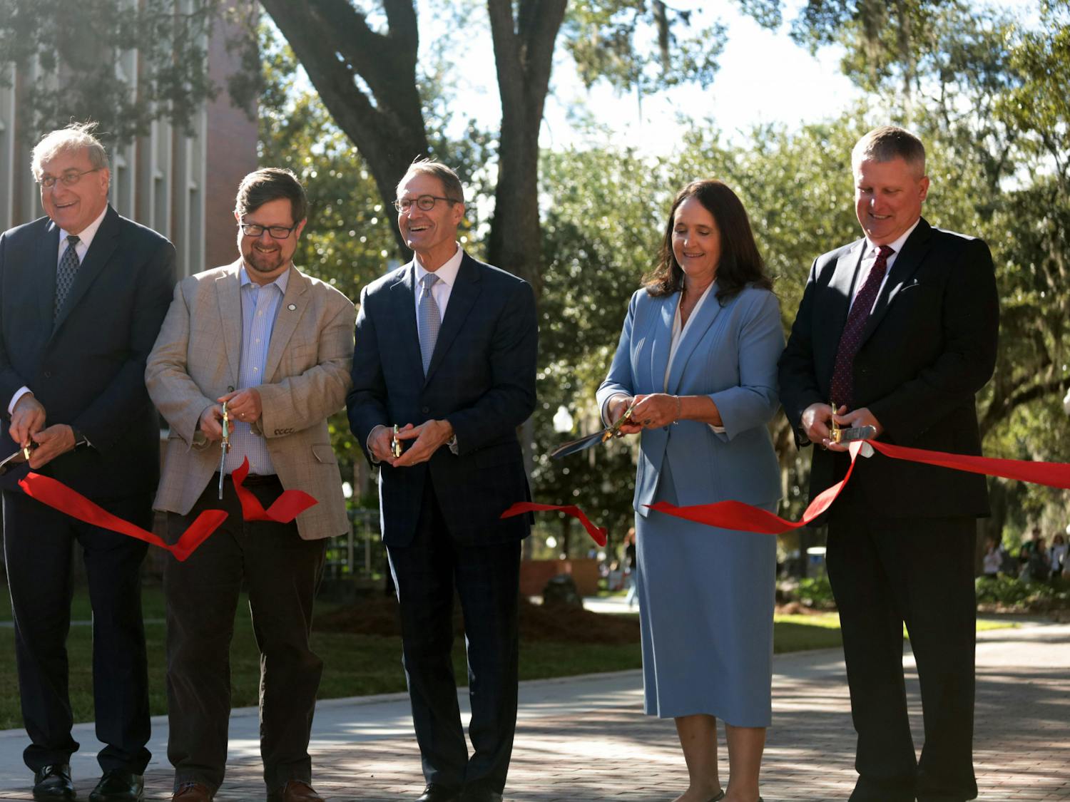 UF President Kent Fuchs, Mayor Lauren Poe and other contributors cut the ribbon at the Newell Gateway Ribbon Cutting Ceremony Wednesday, Oct. 19, 2022.