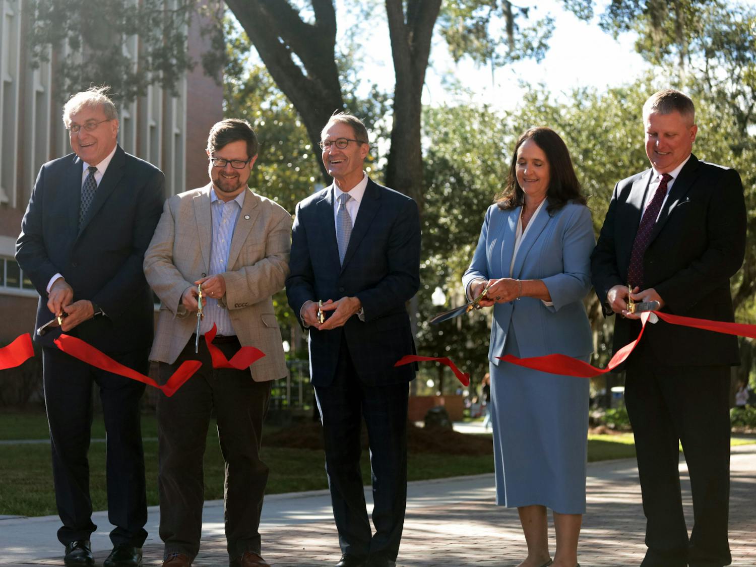 UF President Kent Fuchs, Mayor Lauren Poe and other contributors cut the ribbon at the Newell Gateway Ribbon Cutting Ceremony Wednesday, Oct. 19, 2022.