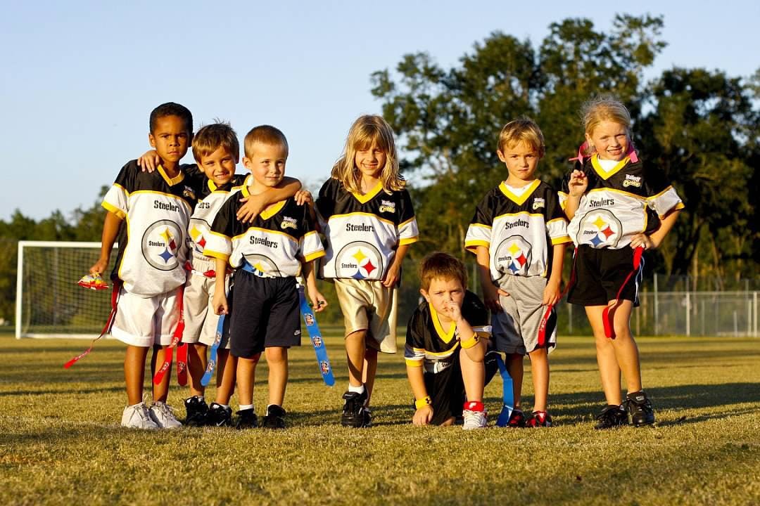 Gabriella Aulisio (center) poses with her flag football team, The Steelers, at the YMCA Sports Complex fields on Archer Road in 2008.
