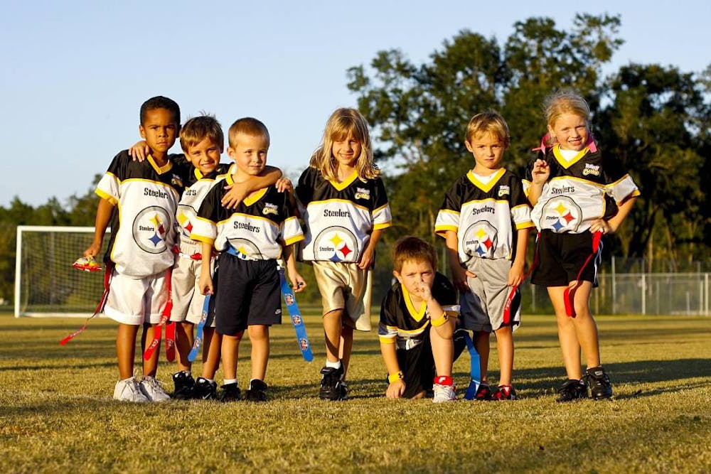 <p>Gabriella Aulisio (center) poses with her flag football team, The Steelers, at the YMCA Sports Complex fields on Archer Road in 2008.</p>