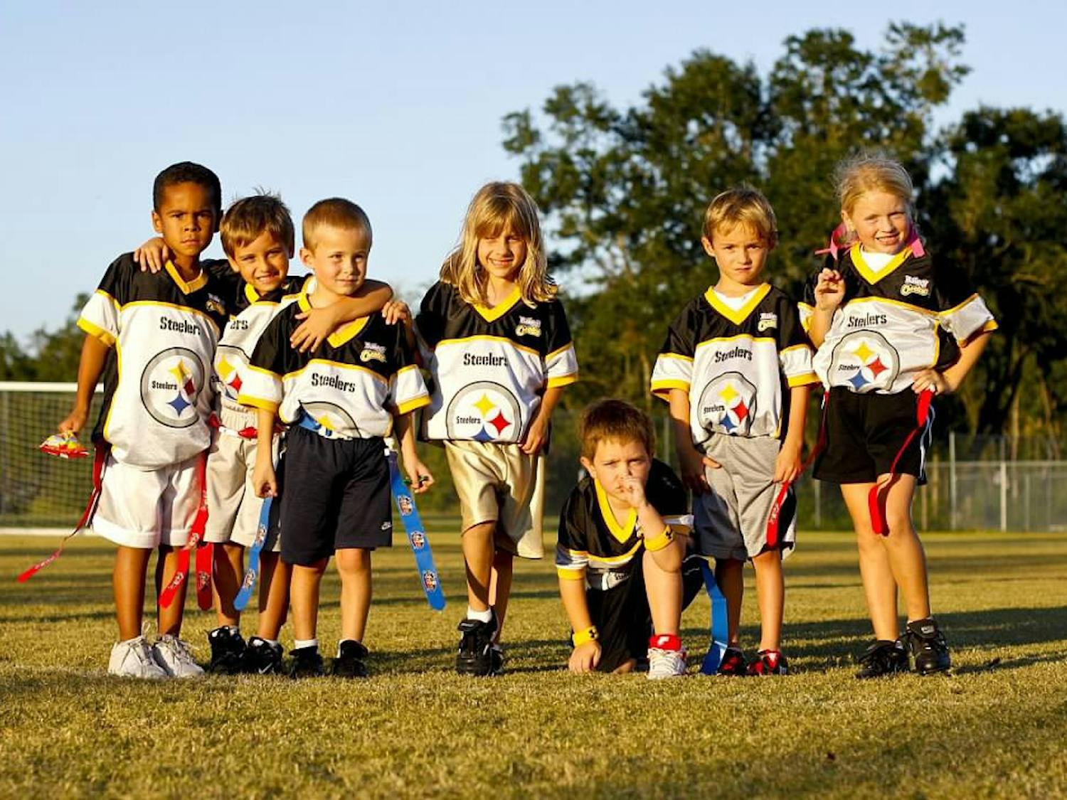 Gabriella Aulisio (center) poses with her flag football team, The Steelers, at the YMCA Sports Complex fields on Archer Road in 2008.