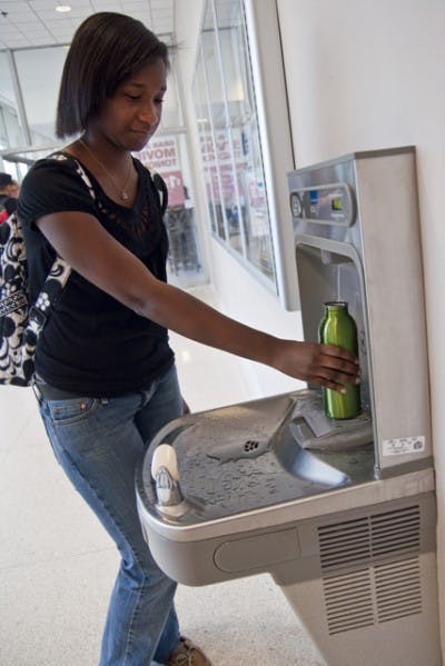 A student refills her environmentally friendly water bottle in the Reitz Union.