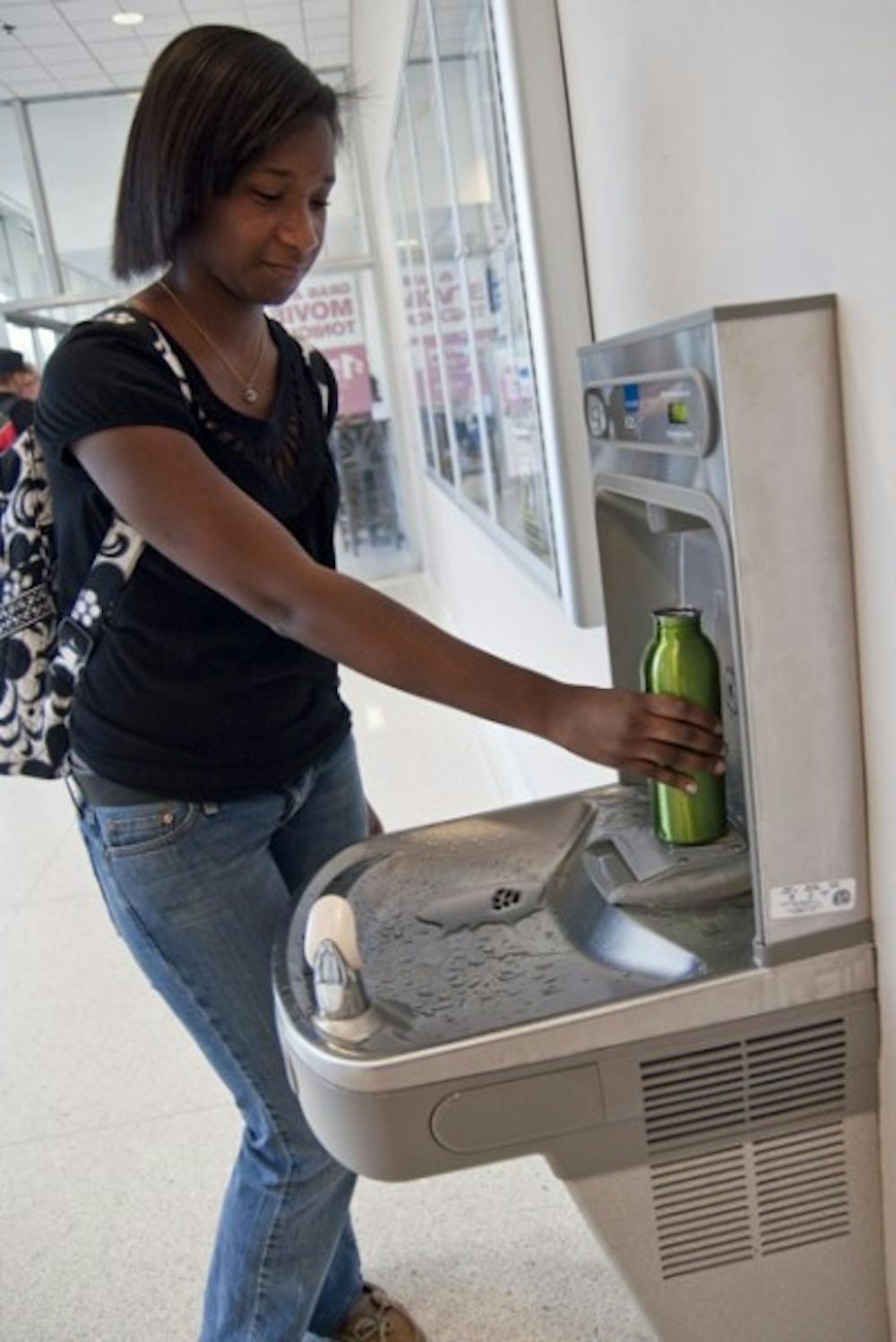 <p>A student refills her environmentally friendly water bottle in the Reitz Union.</p>