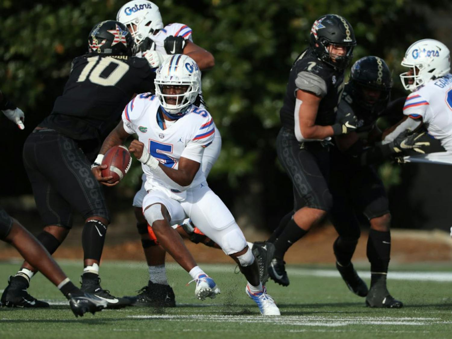 Gators backup quarterback Emory Jones zig zags between Vanderbilt defenders in Nashville, Tennessee, on Nov. 21. Jones threw Florida’s final touchdown pass in their 38-17 win over the Commodores Saturday.