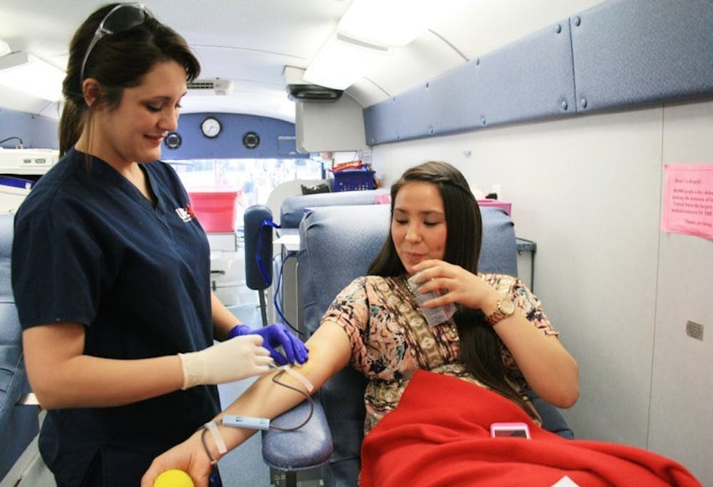 <p>Santa Fe criminal justice junior Samantha Baker, 21, takes blood from UF advertising sophomore Tiffany Sanders, 19, who said she has given blood every two months since she started attending UF. "It's easy to just come in when you have a break from class," Sanders said.</p>