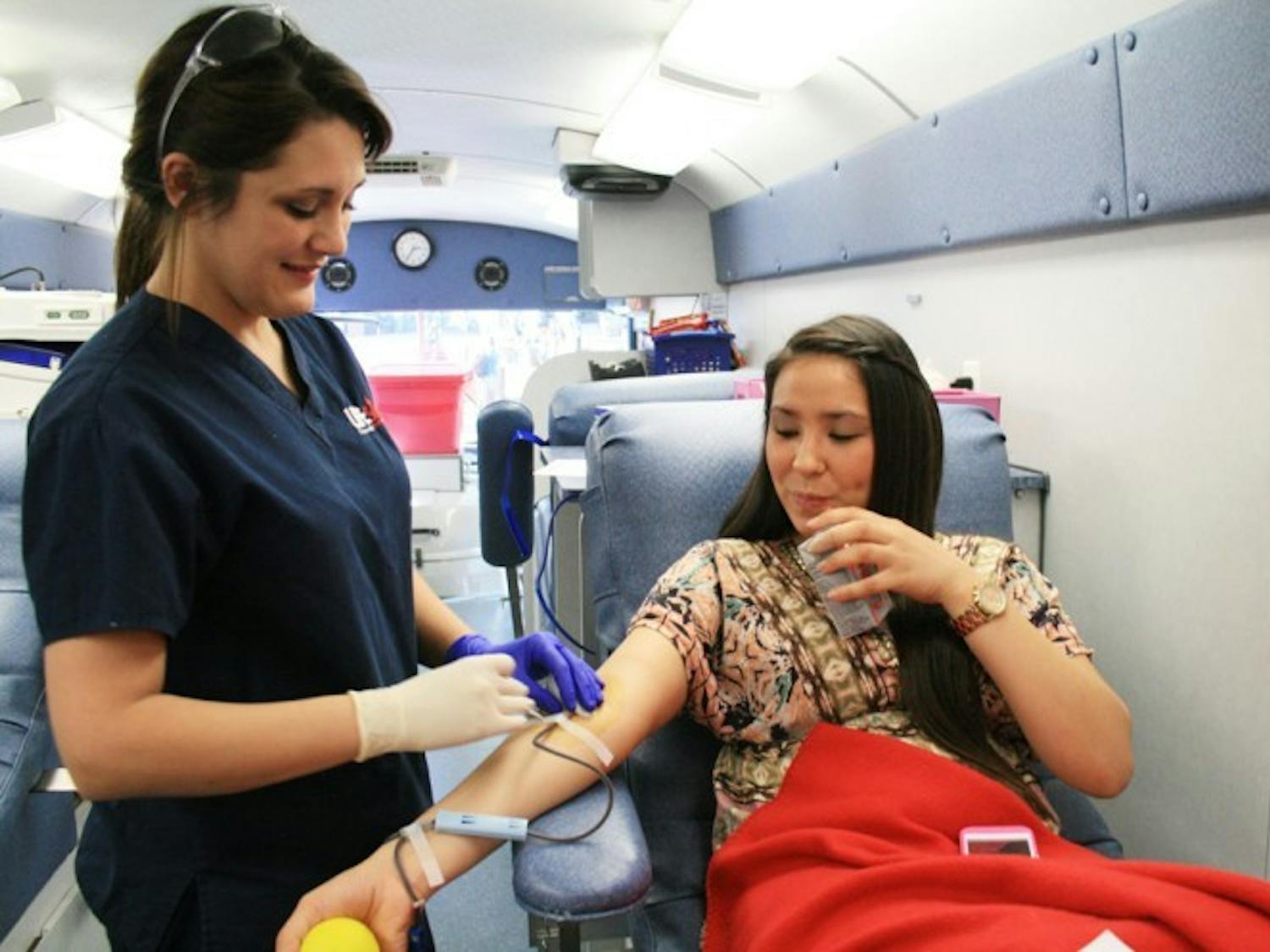Santa Fe criminal justice junior Samantha Baker, 21, takes blood from UF advertising sophomore Tiffany Sanders, 19, who said she has given blood every two months since she started attending UF. "It's easy to just come in when you have a break from class," Sanders said.