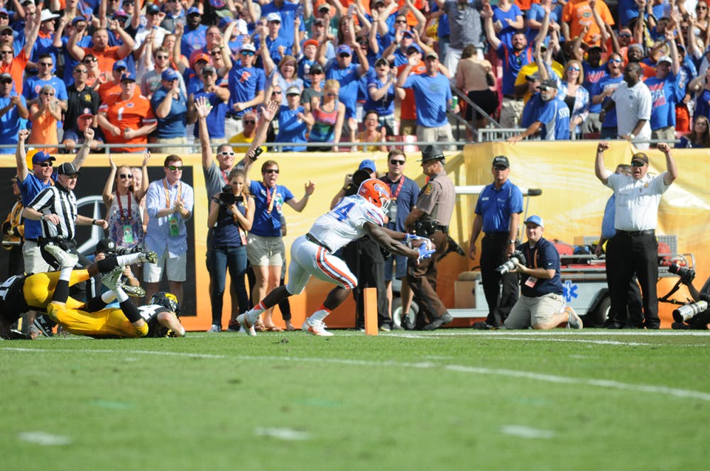 <p>Mark Thompson dives for the end zone to cap an 85-yard touchdown catch during Florida's 30-3 win over Iowa in the Outback Bowl. </p>
