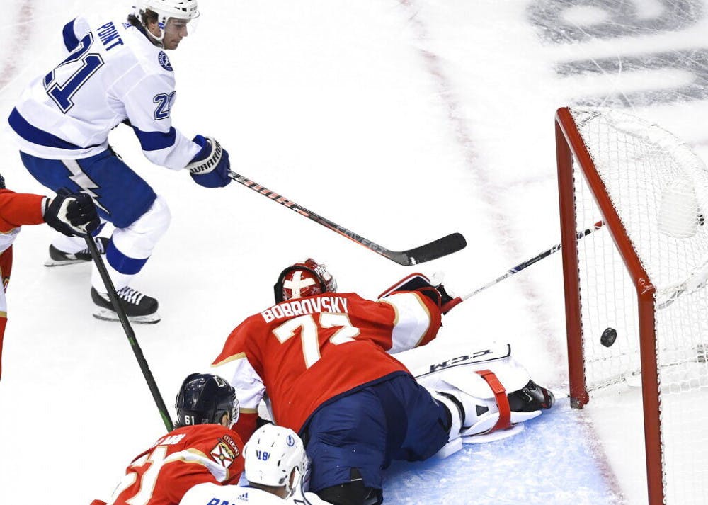 Tampa Bay Lightning center Brayden Point (21) scores past Florida Panthers goaltender Sergei Bobrovsky (72) during the first period of an exhibition NHL hockey game in Toronto, Wednesday, July 29, 2020. (Nathan Denette/The Canadian Press via AP)