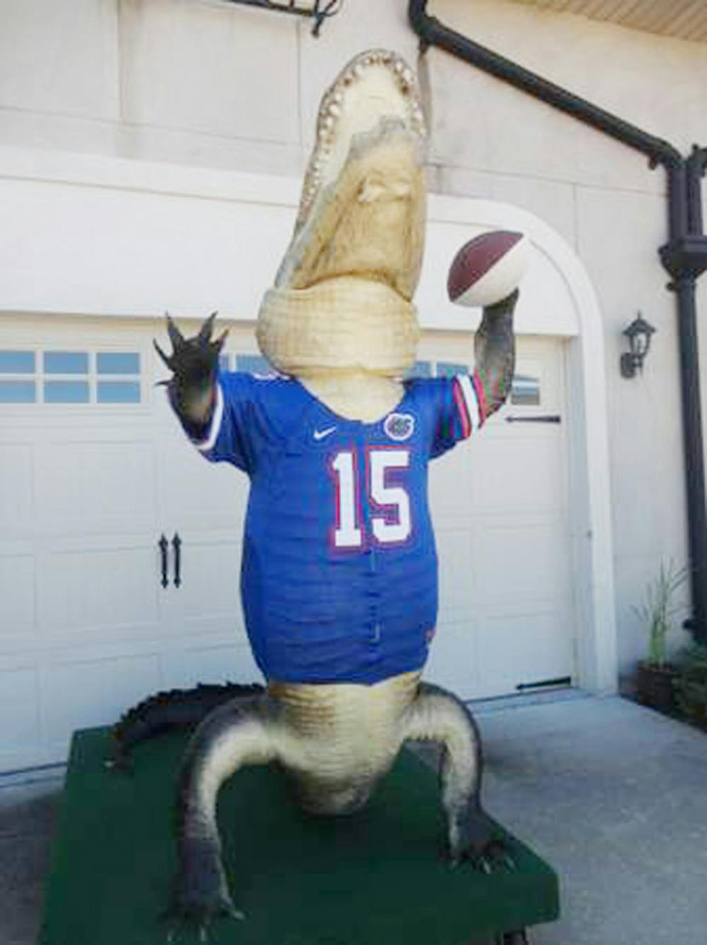 <p class="p1"><span class="s1"><span class="s1">A 13-foot-4-inch bull alligator is mounted in the Heisman Trophy pose. He holds a football signed by Tim Tebow,</span> Steve Spurrier and Danny Wuerffel.</span></p>