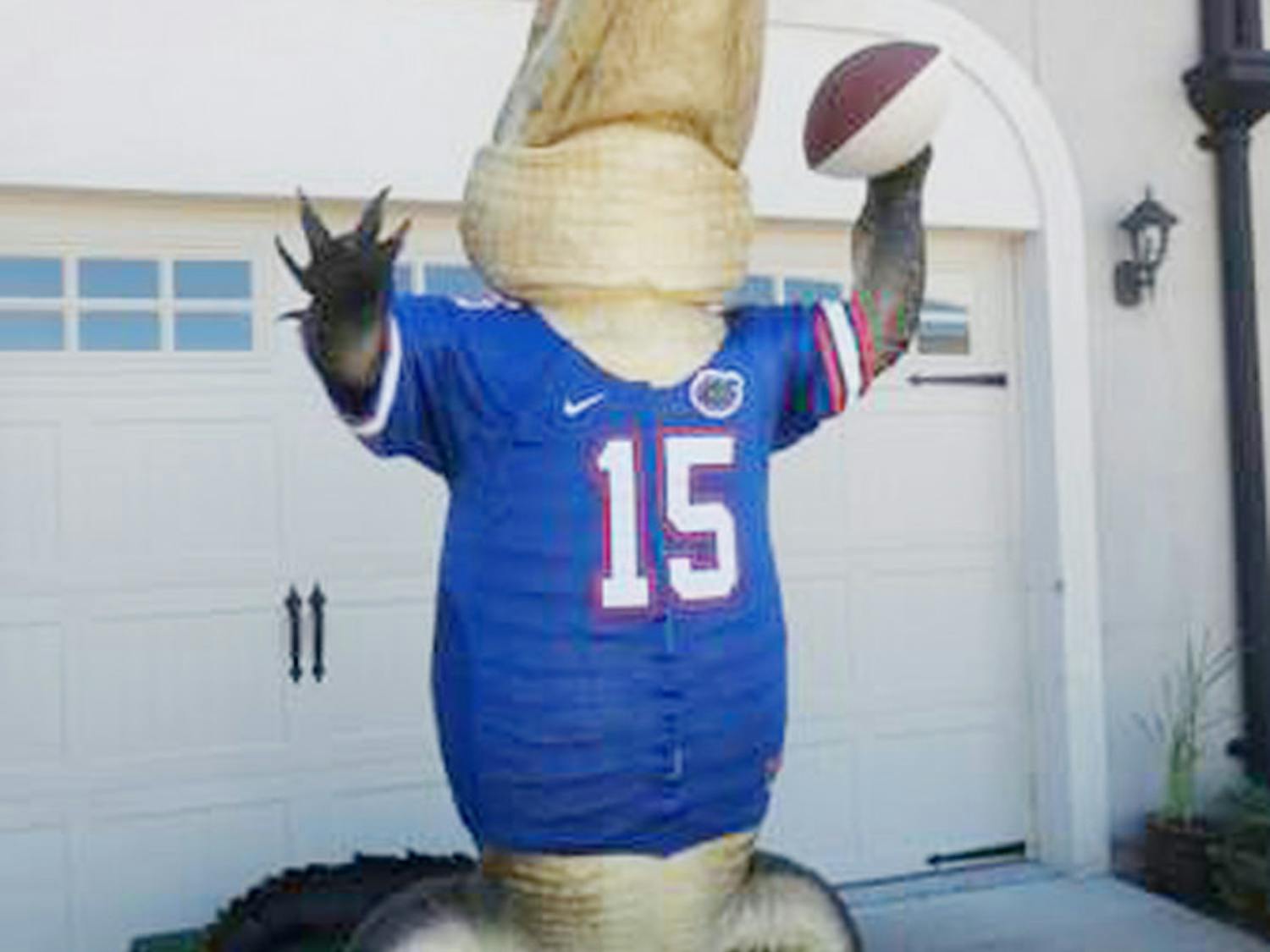 A 13-foot-4-inch bull alligator is mounted in the Heisman Trophy pose. He holds a football signed by Tim Tebow, Steve Spurrier and Danny Wuerffel.
