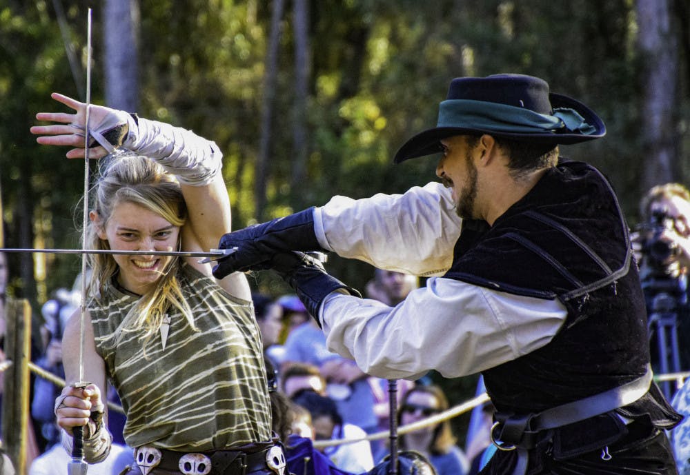 Thieves Guilde actors Sierra Barnier, 18, and Kevin Otero, 24, perform a choreographed sword fight during a chess game.
