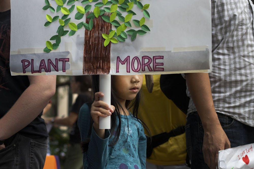 Mika Lee, 6, holds participates in the climate protest Sept. 20 at City Hall. 