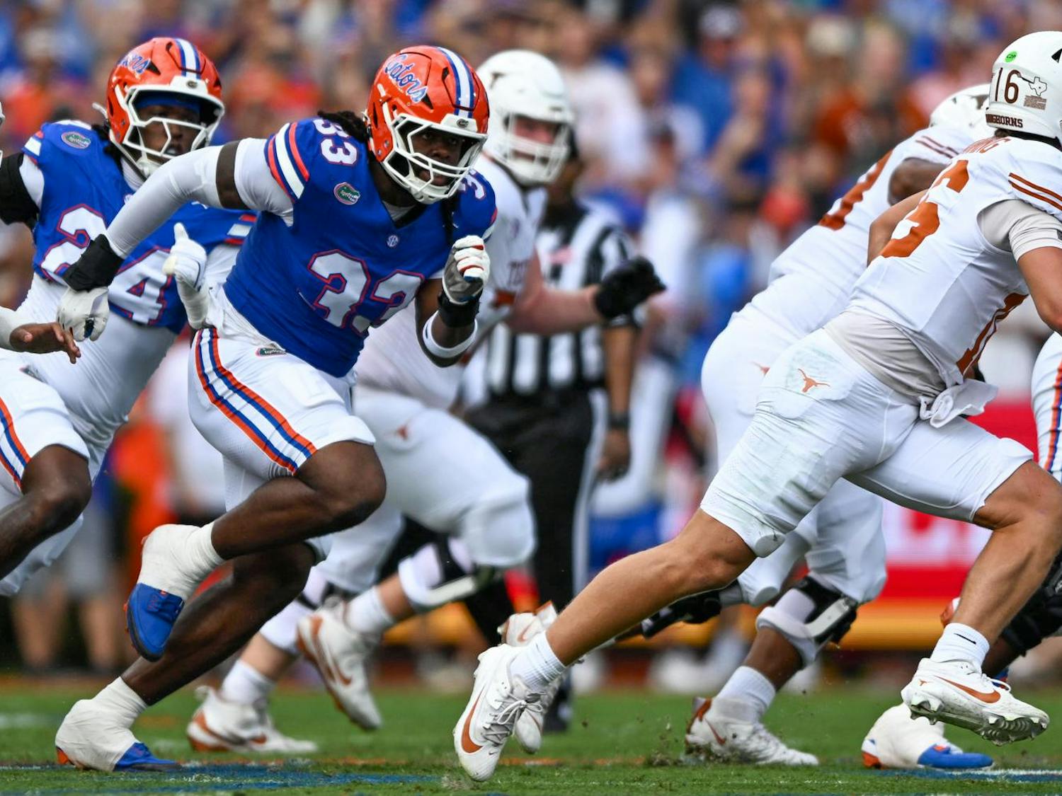 Florida Gators defensive lineman Brien Taylor Jr. (33) runs after Texas Longhorns quarterback Arch Manning (16) during a football game between the Texas Longhorns and the Florida Gators on Saturday, Oct. 4, 2025, at Ben Hill Griffin Stadium in Gainesville, Fla.