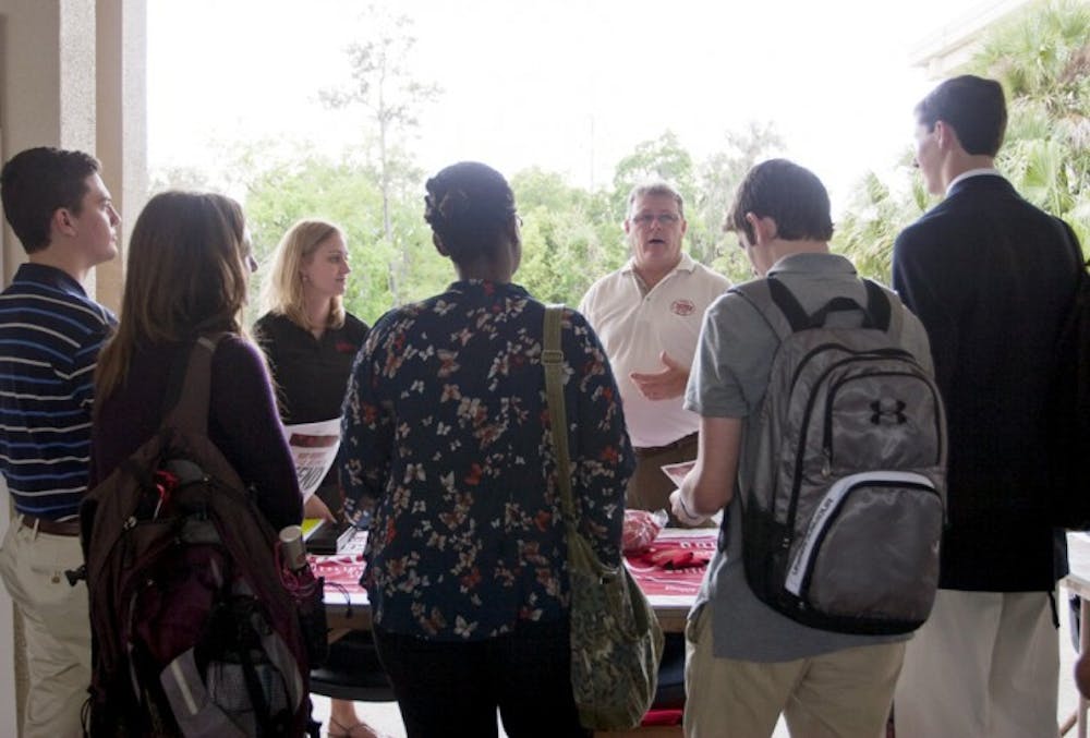 <p>Sales and Marketing Representative Joy Richie and Regional Sales Manager Robbie Jones of Cheerwine describe the perks of being a Cheerwine campus ambassador on Thursday afternoon at the summer job and internship fair.</p>