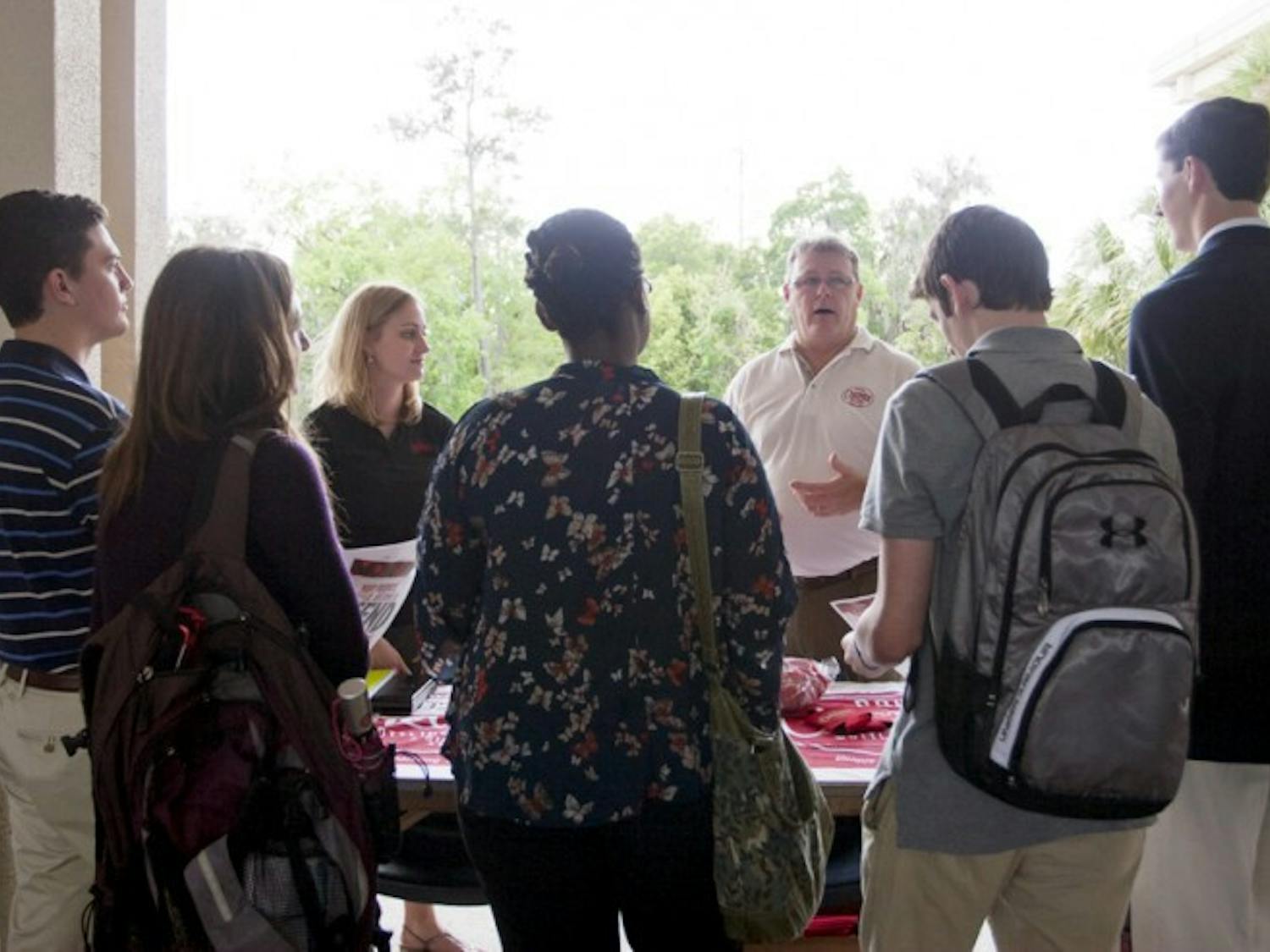 Sales and Marketing Representative Joy Richie and Regional Sales Manager Robbie Jones of Cheerwine describe the perks of being a Cheerwine campus ambassador on Thursday afternoon at the summer job and internship fair.