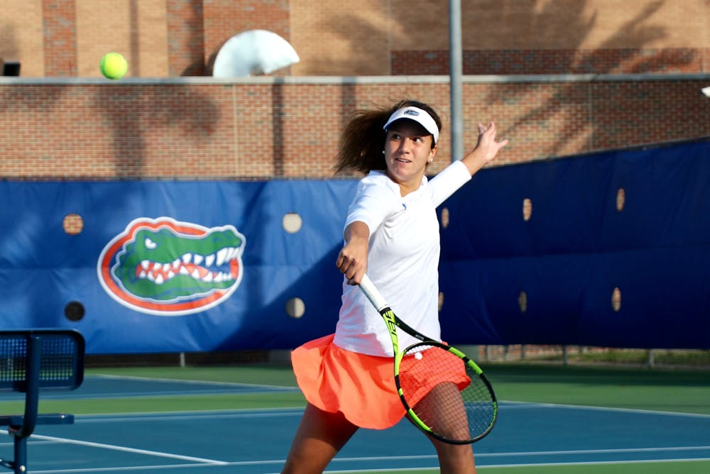 <p>Anna Danilina returns a backhand during Florida's 4-2 win against Oklahoma State on Feb. 18, 2017, at the Ring Tennis Complex.</p>