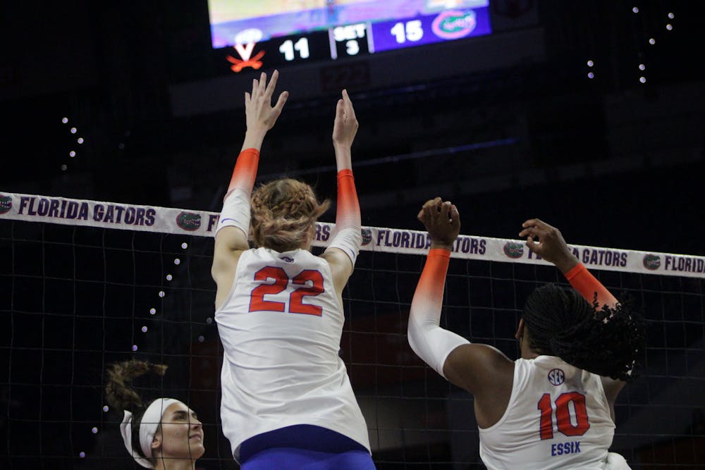 Outside hitter Marina Markova and middle blocker Gabrielle Essix rise above the net for a block against Virginia Aug. 27, 2022. 