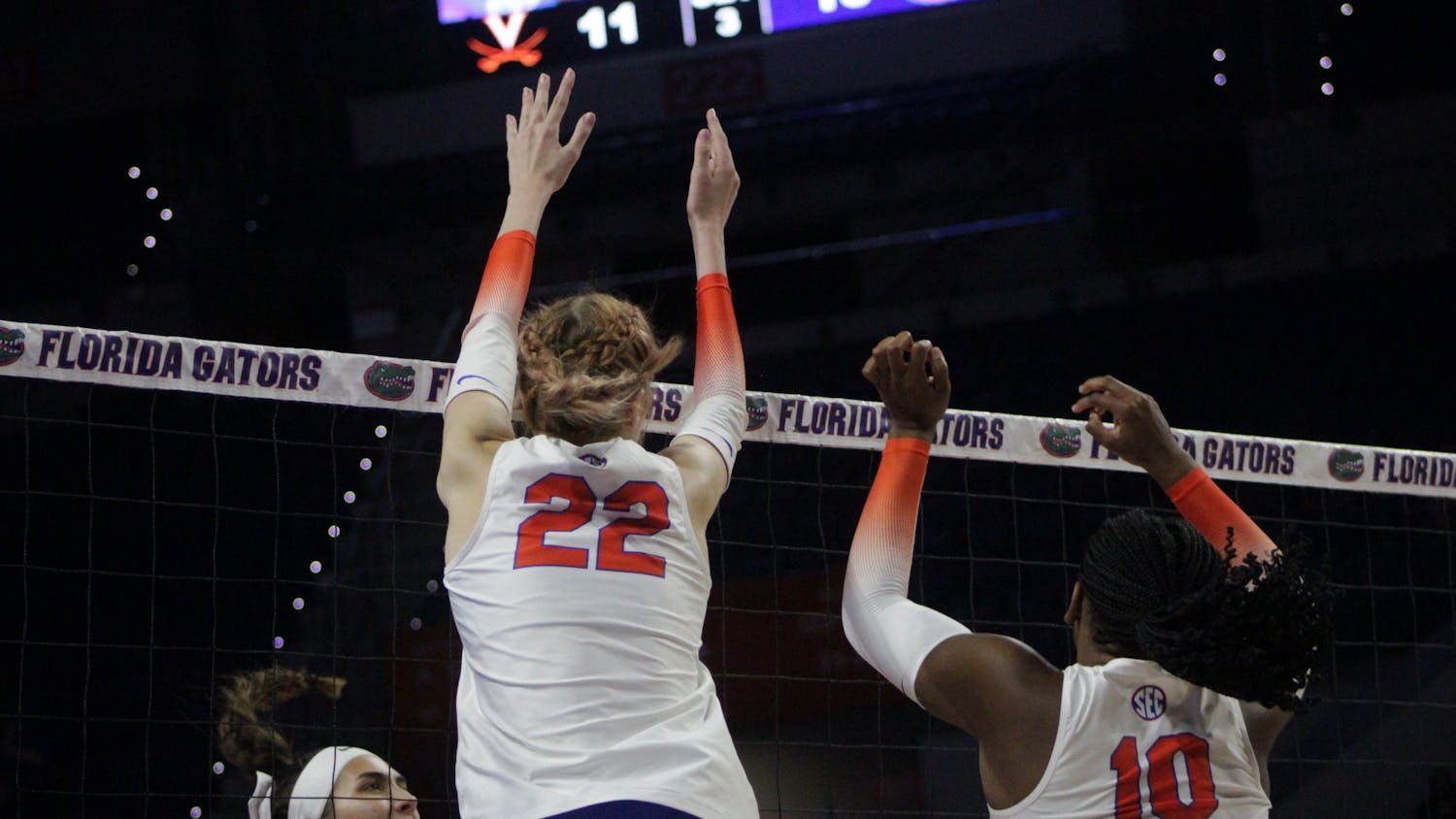 Outside hitter Marina Markova and middle blocker Gabrielle Essix rise above the net for a block against Virginia Aug. 27, 2022. 