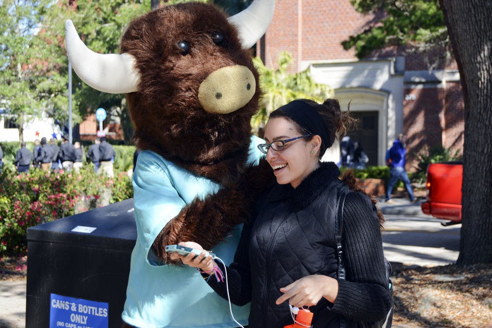 <p>Helen Roldan, a 22-year-old UF political science senior, smiles while looking at the photo she took of herself with the YikYak mascot.”It’s just really funny,” Roldan said. “I go on there a lot to laugh and see what's going on on campus.”</p>