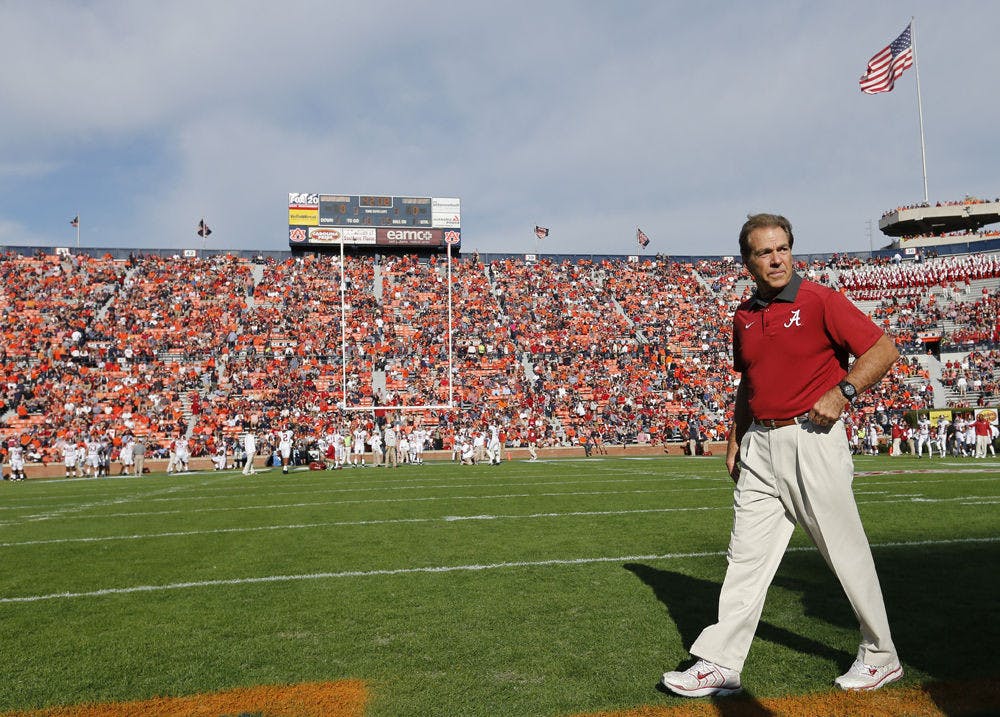 Alabama head coach Nick Saban walks across the football field before an NCAA college football game against Auburn on Saturday in Auburn, Alabama.