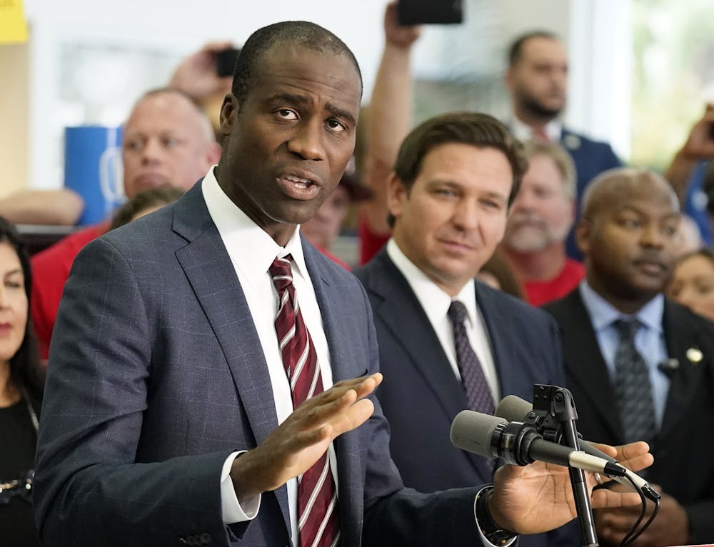 <p>Florida Surgeon General Dr. Joseph Ladapo, front left, gestures as he speaks to supporters and members of the media before a bill signing by Gov. Ron DeSantis, front right, Nov. 18, 2021, in Brandon, Fla. (AP Photo/Chris O&#x27;Meara, File)</p>