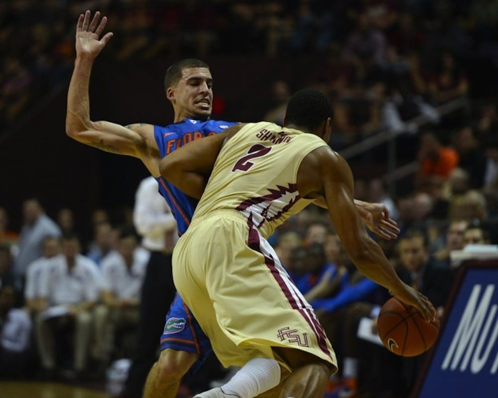 <p>Junior guard Scottie Wilbekin blocks Florida State forward Terrance Shannon during Florida's 72-47 win against Florida State in Tallahassee on Wednesday, Dec. 5, 2012.</p>