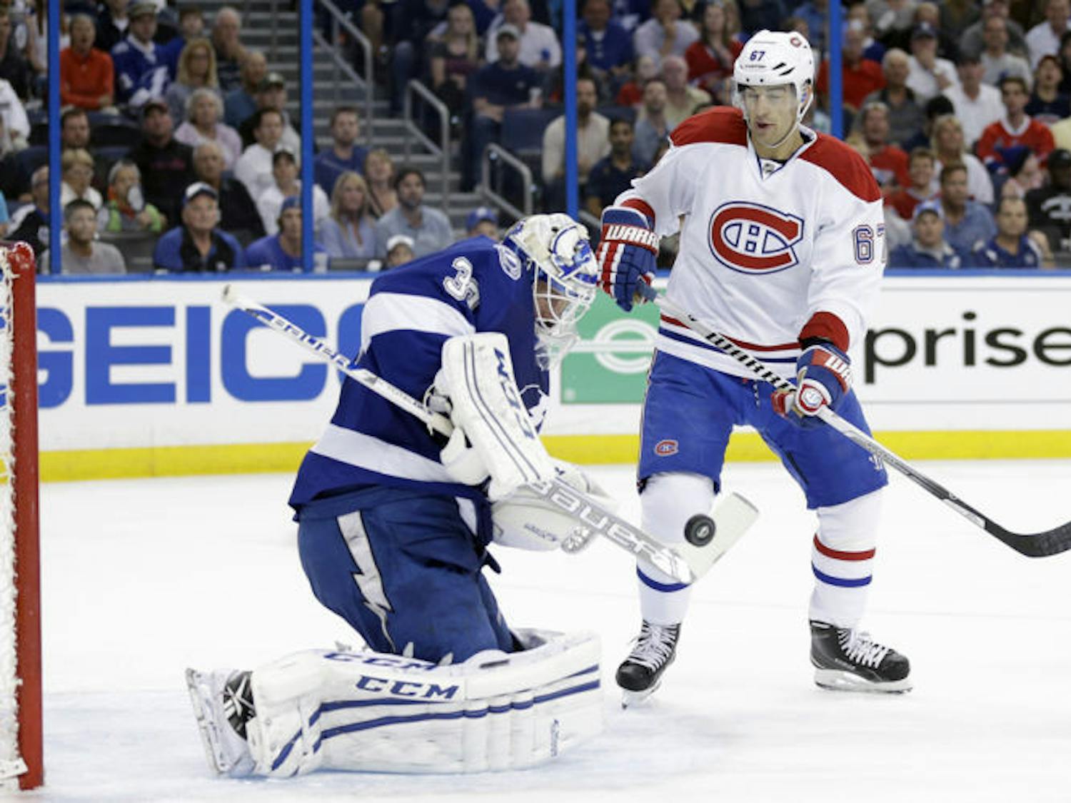 Tampa Bay goalie Anders Lindback (39) makes a save as Montreal winger Max Pacioretty (67) looks for a rebound during Game 1 of their first-round playoff series in Tampa.