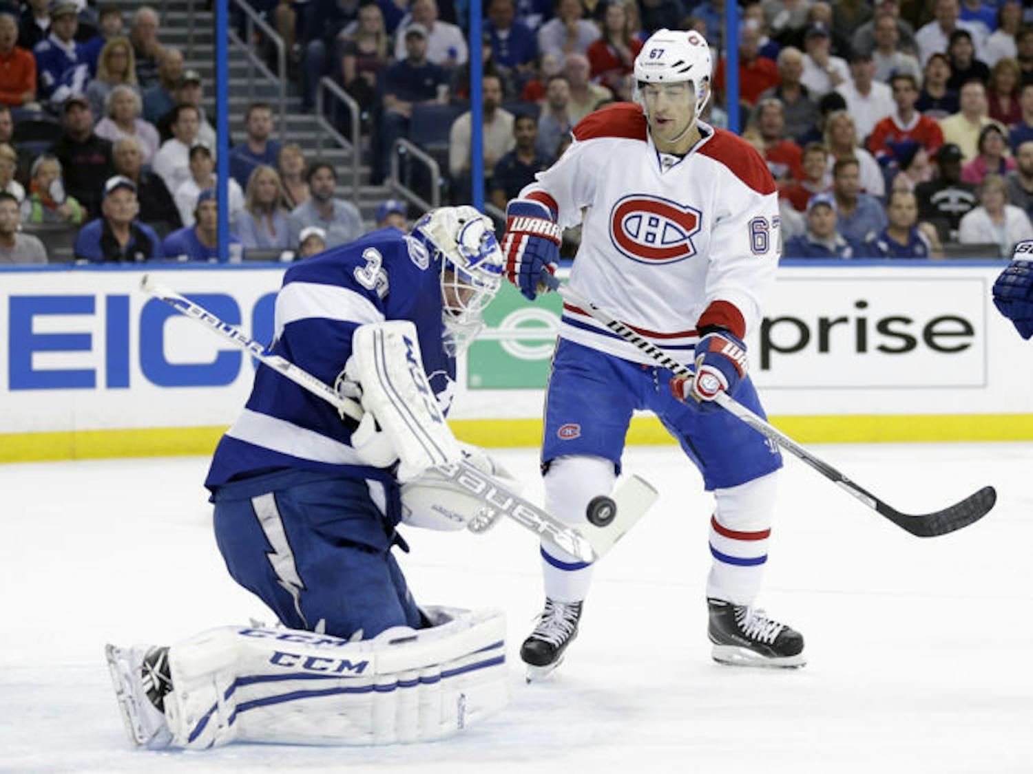 Tampa Bay goalie Anders Lindback (39) makes a save as Montreal winger Max Pacioretty (67) looks for a rebound during Game 1 of their first-round playoff series in Tampa.