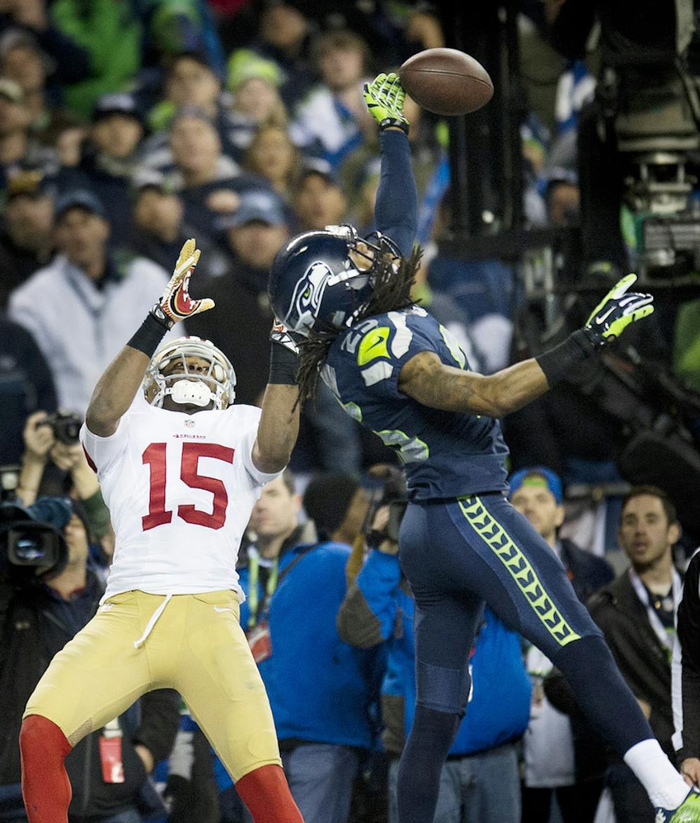 <p>Seattle cornerback Richard Sherman (25) hits the ball away from San Francisco receiver Michael Crabtree (15) during the NFC Championship game on Sunday in Seattle.</p>