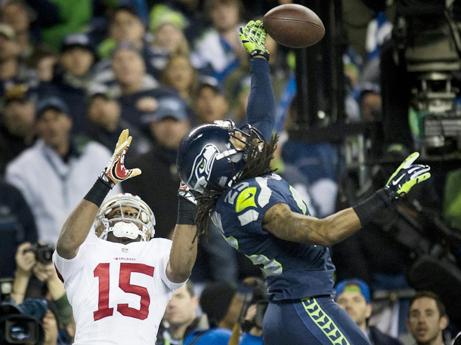Seattle cornerback Richard Sherman (25) hits the ball away from San Francisco receiver Michael Crabtree (15) during the NFC Championship game on Sunday in Seattle.