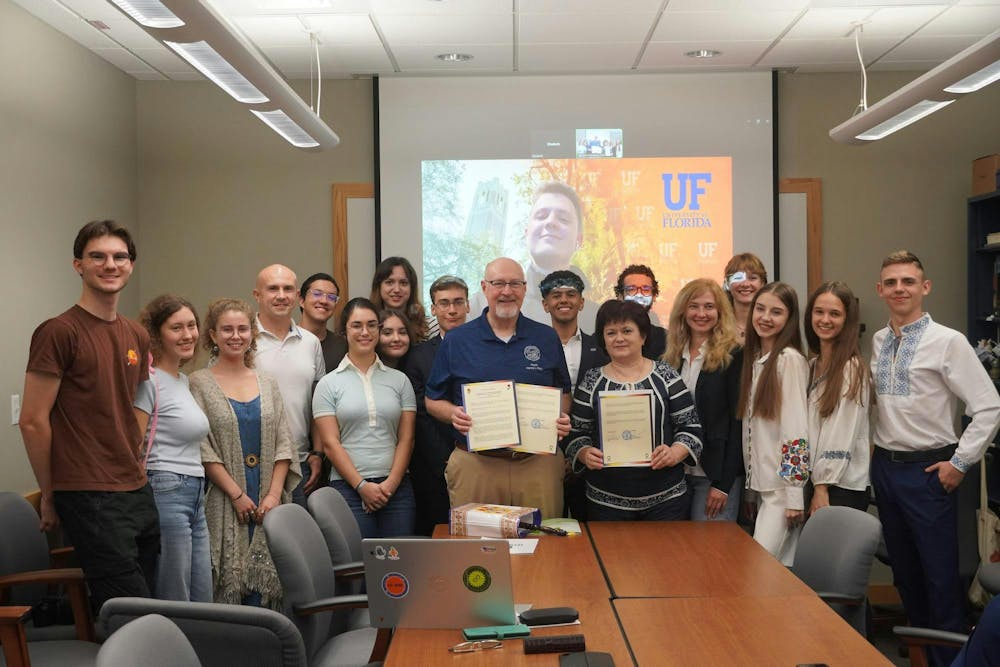 <p>UF Ukraine Rebuilding Initiative members stand with Gainesville mayor to mark sister-city partnership Oct. 31, 2024.</p>