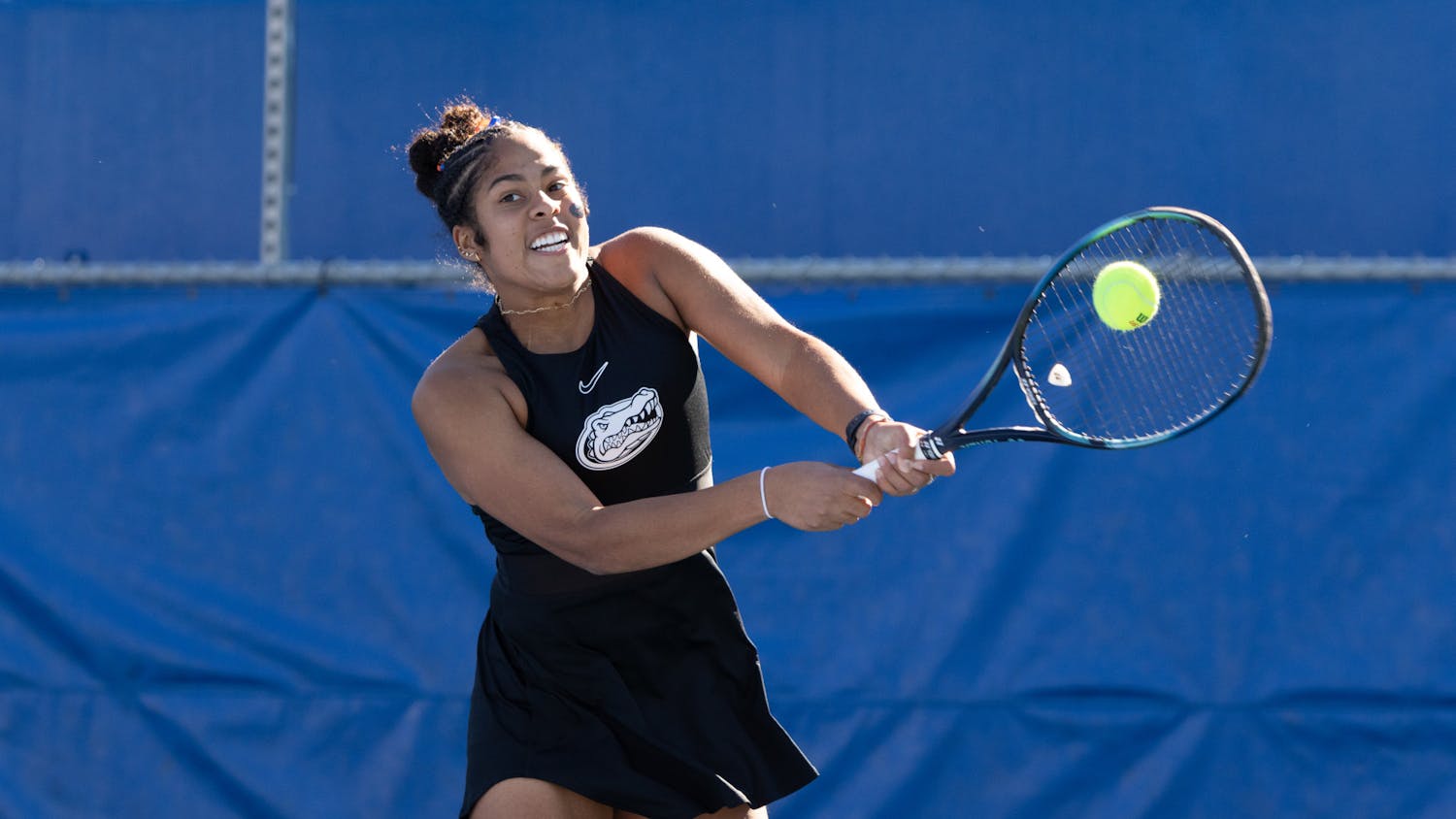 Freshman Qavia Lopez slams a hit in the Gators women's tennis 6-1 win against Baylor. 
