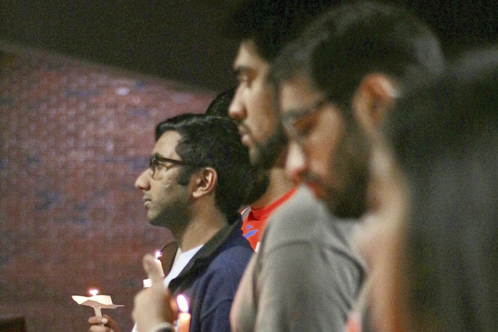 Omar Khan stands alongside other members and supporters of Islam on Campus on listening to the details of the late February slaying of three men in Fort Wayne, Indiana. The 21-year-old mechanical engineering junior said the fact that he didn't know about the murders until now spoke volumes, and he hoped the vigil would bring a little light to the subject.