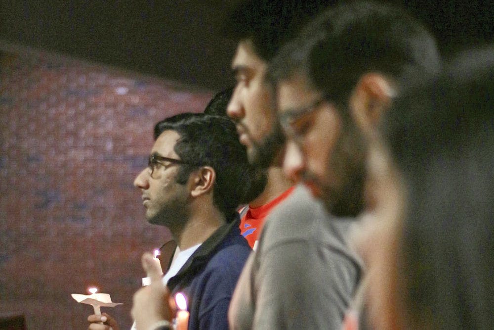 <p>Omar Khan stands alongside other members and supporters of Islam on Campus on listening to the details of the late February slaying of three men in Fort Wayne, Indiana. The 21-year-old mechanical engineering junior said the fact that he didn't know about the murders until now spoke volumes, and he hoped the vigil would bring a little light to the subject.</p>