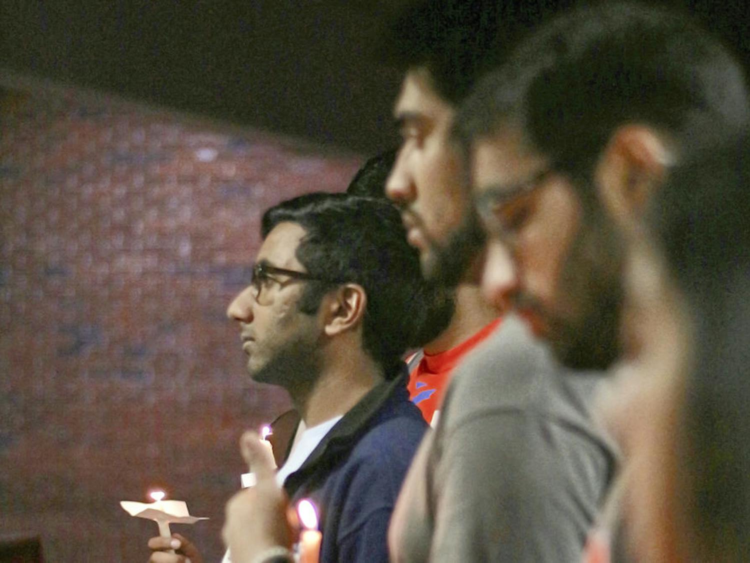 Omar Khan stands alongside other members and supporters of Islam on Campus on listening to the details of the late February slaying of three men in Fort Wayne, Indiana. The 21-year-old mechanical engineering junior said the fact that he didn't know about the murders until now spoke volumes, and he hoped the vigil would bring a little light to the subject.