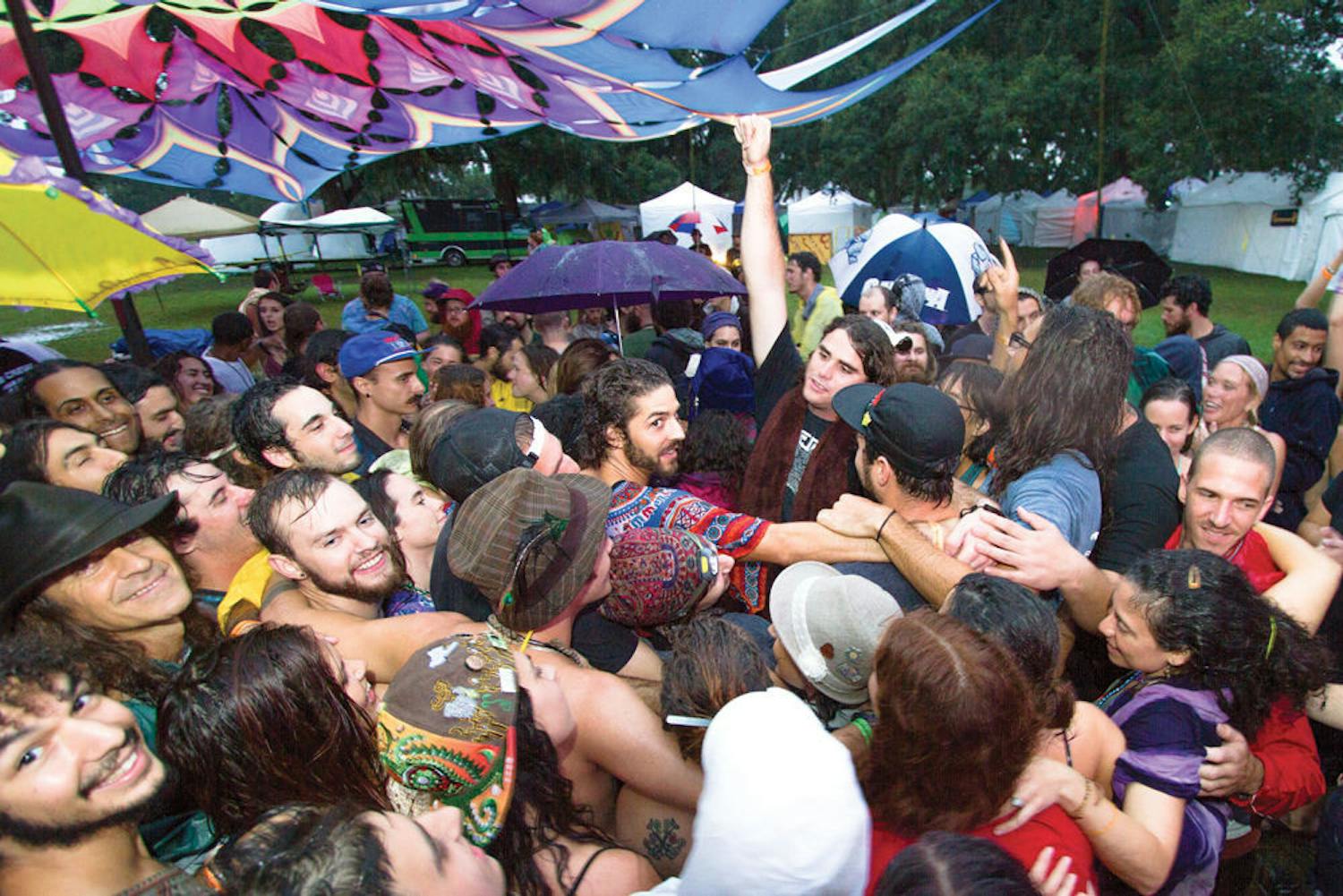 Earthdance attendees huddle together for a group hug at Maddox Ranch in Lakeland, Florida Saturday September 20, 2014.
