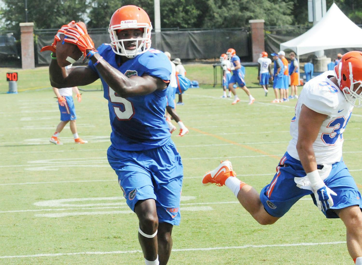 UF wide receiver Ahmad Fulwood catches a pass from quarterback Will Grier (not pictured) during practice Aug. 8, 2015, at Donald R. Dizney Stadium.