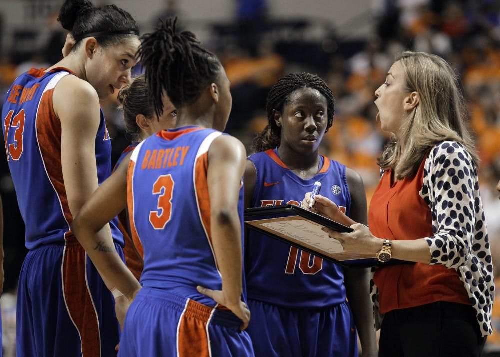 Florida head coach Amanda Butler, right, talks to Azania Stewart (13), Lanita Bartley (3) and Jaterra Bonds (10) in the second half of Kentucky's 71-67 win Friday at the SEC Tournament. 