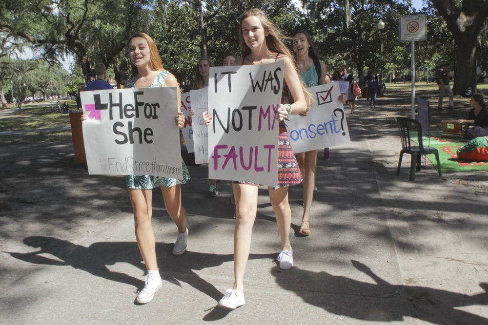 HeFor She President Lillian Rozsa (left), a 19-year-old UF political science and women's studies sophomore, and secretary Whitney Hall, a 19-year-old UF biology sophomore, lead the “Dress Does Not Mean Yes” walk from the Plaza of the Americas to Turlington Plaza on Oct. 8, 2015. Hall said the march was to express solidarity with sexual assault victims and determination to end rape culture.