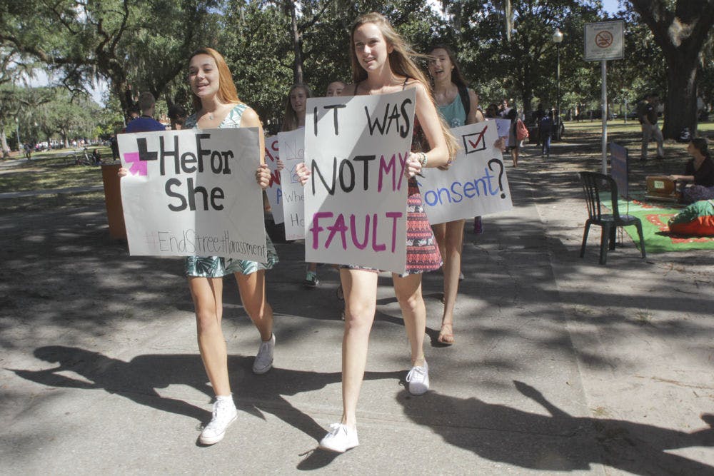 <p>HeFor She President Lillian Rozsa (left), a 19-year-old UF political science and women's studies sophomore, and secretary Whitney Hall, a 19-year-old UF biology sophomore, lead the “Dress Does Not Mean Yes” walk from the Plaza of the Americas to Turlington Plaza on Oct. 8, 2015. Hall said the march was to express solidarity with sexual assault victims and determination to end rape culture.</p>
