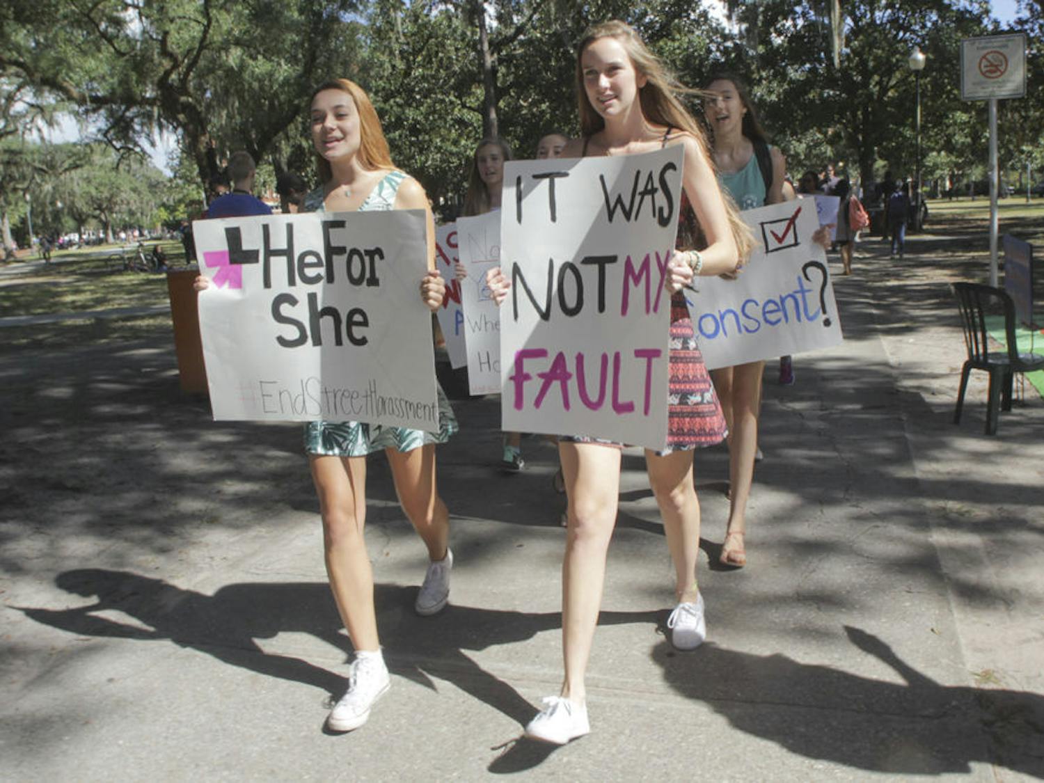 HeFor She President Lillian Rozsa (left), a 19-year-old UF political science and women's studies sophomore, and secretary Whitney Hall, a 19-year-old UF biology sophomore, lead the “Dress Does Not Mean Yes” walk from the Plaza of the Americas to Turlington Plaza on Oct. 8, 2015. Hall said the march was to express solidarity with sexual assault victims and determination to end rape culture.