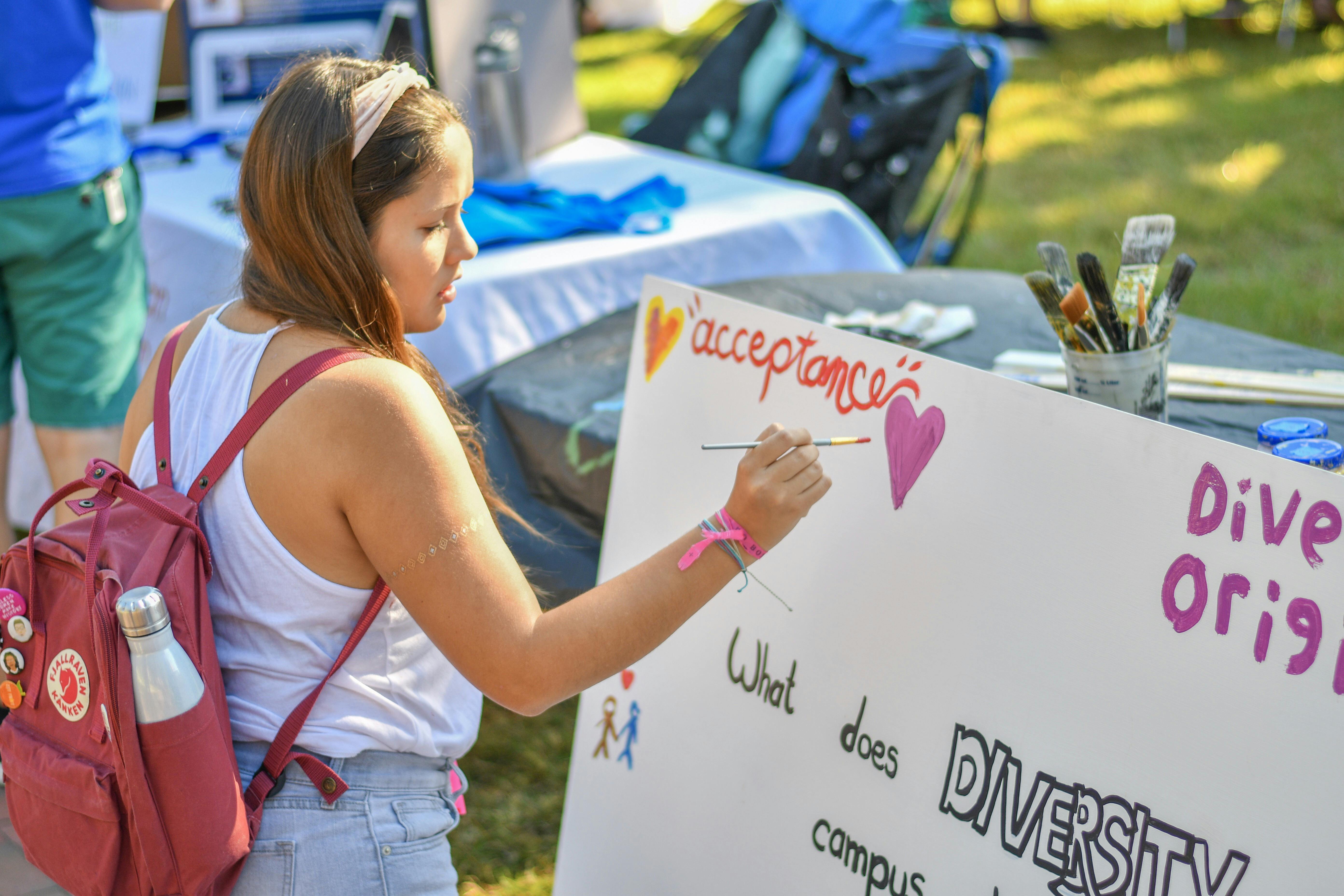 Daniela Ordonez, an 18-year-old freshman UF political science major, paints on the “Diversity” mural started by the UF Center for Arts and Medicine. The mural was created to showcase the diversity at UF by allowing any student to add to it and put their own spin on the painting.