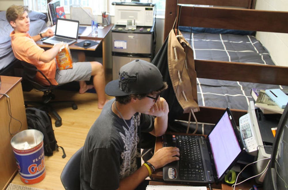 <p>Animal science sophomore Justin Hanson, 19, right, and engineering freshman William Walker, 18, left, pass time in their dorm room Monday afternoon in Simpson Hall.</p>