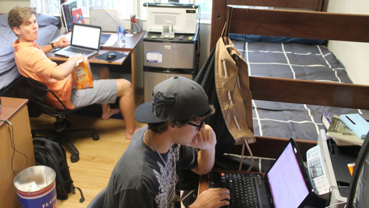 Animal science sophomore Justin Hanson, 19, right, and engineering freshman William Walker, 18, left, pass time in their dorm room Monday afternoon in Simpson Hall.