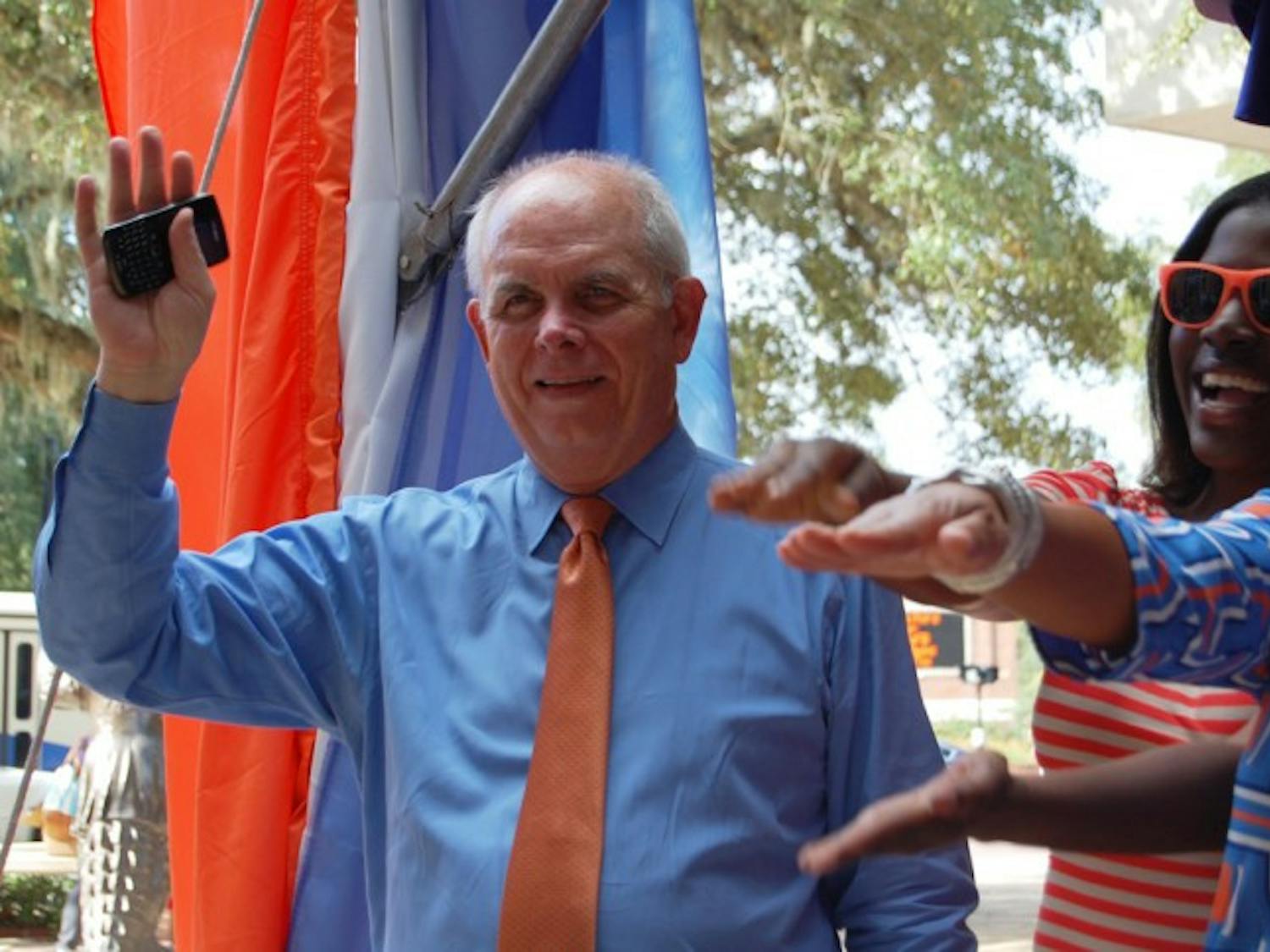 UF President Bernie Machen waves to Gators during the BEAT LSU T-Shirt Giveaway at Emerson Hall on the morning of Oct. 5. Among other guest speakers, Machen spoke to students about the Florida Opportunity Scholars Program.