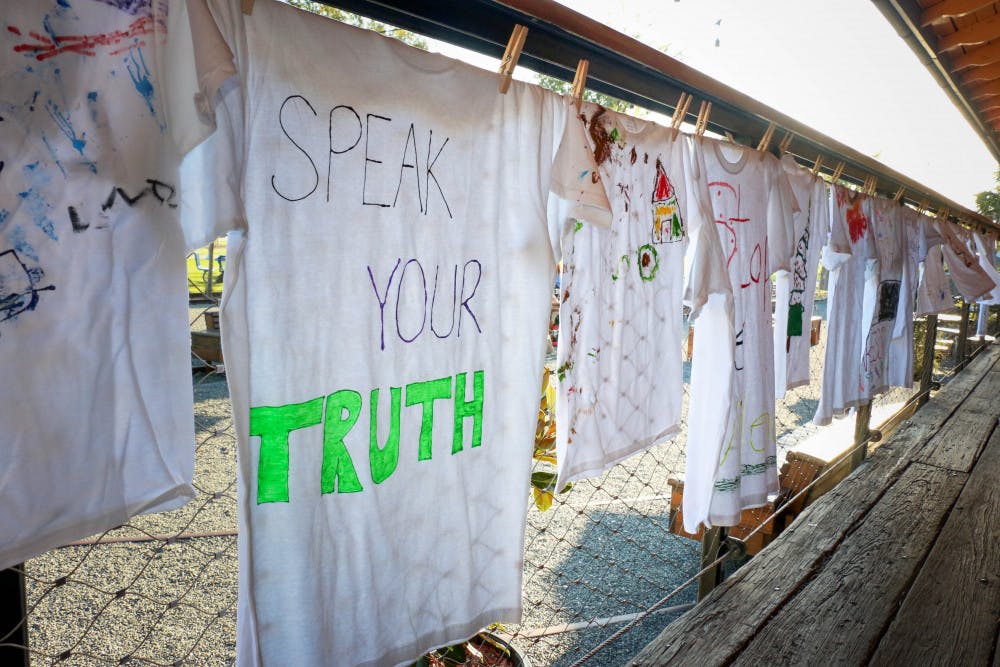 Forty-nine shirts lined the walkway at Depot Park on Oct. 4, 2018, during the Domestic Violence Community Vigil and Clothesline Project Exhibit. The Clothesline Project began in 1990 and was created to honor survivors of domestic violence and educate others about the reality of abuse. The shirts were decorated by women and children who survived domestic violence.