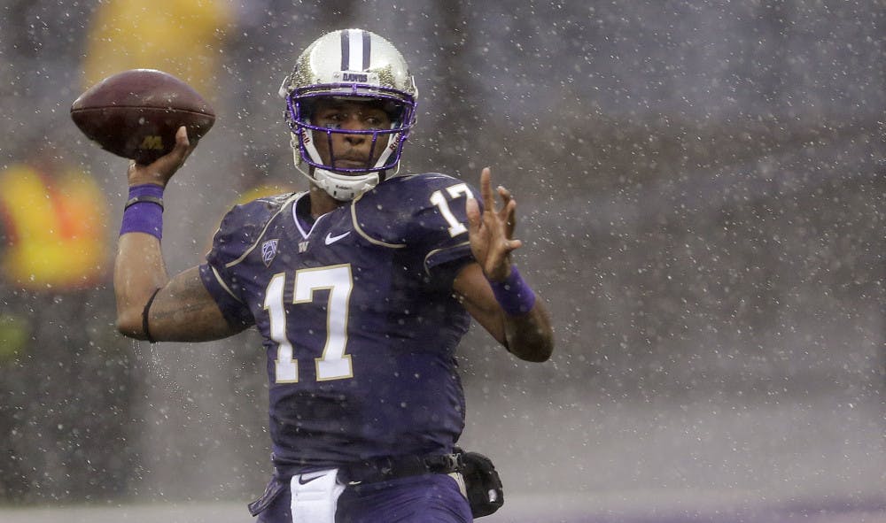 <p>Washington quarterback Keith Price passes in the rain during the first half of UW's 31-13 win against Arizona on Saturday in Seattle.</p>